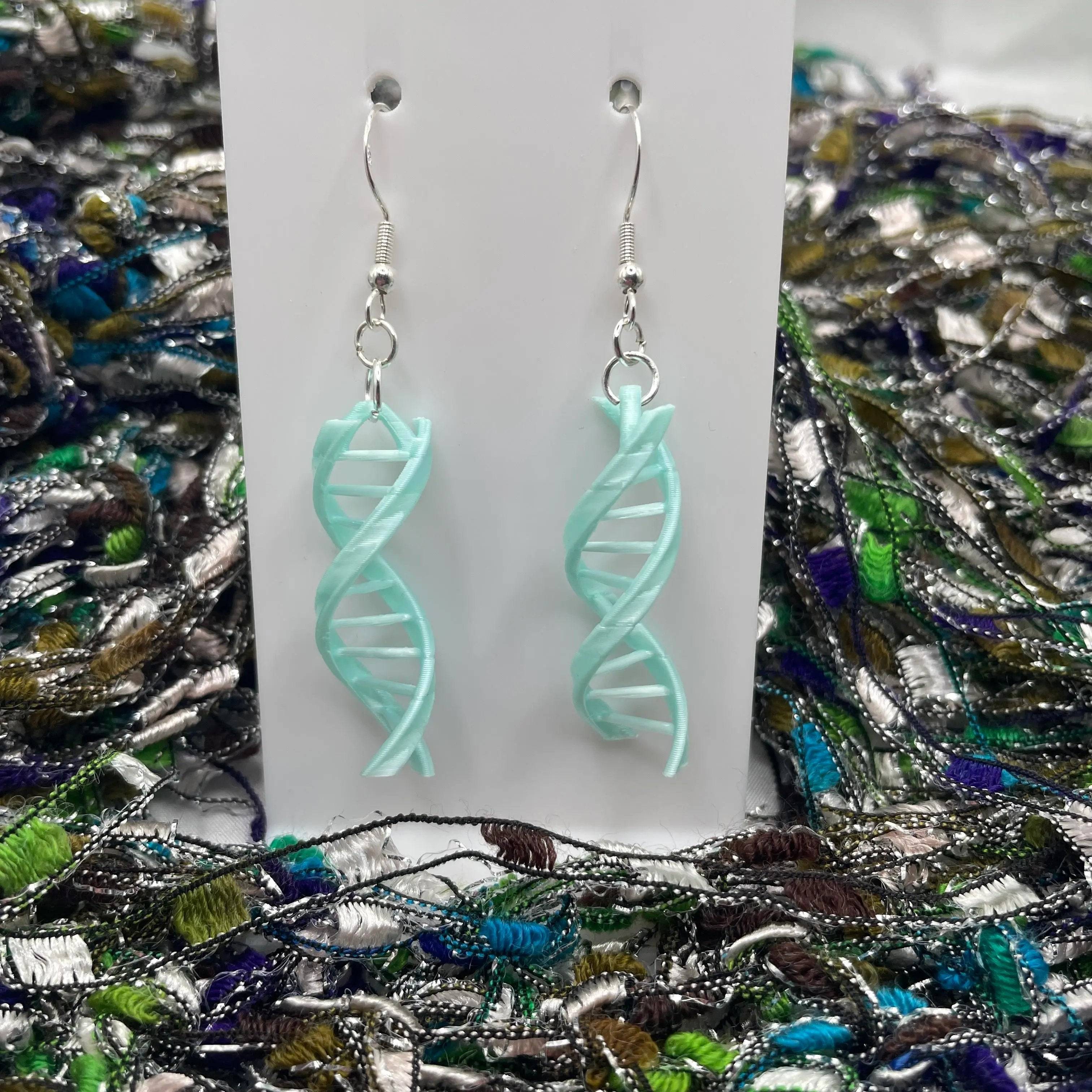 Double Helix DNA Dangle Earrings come in a light blue color.