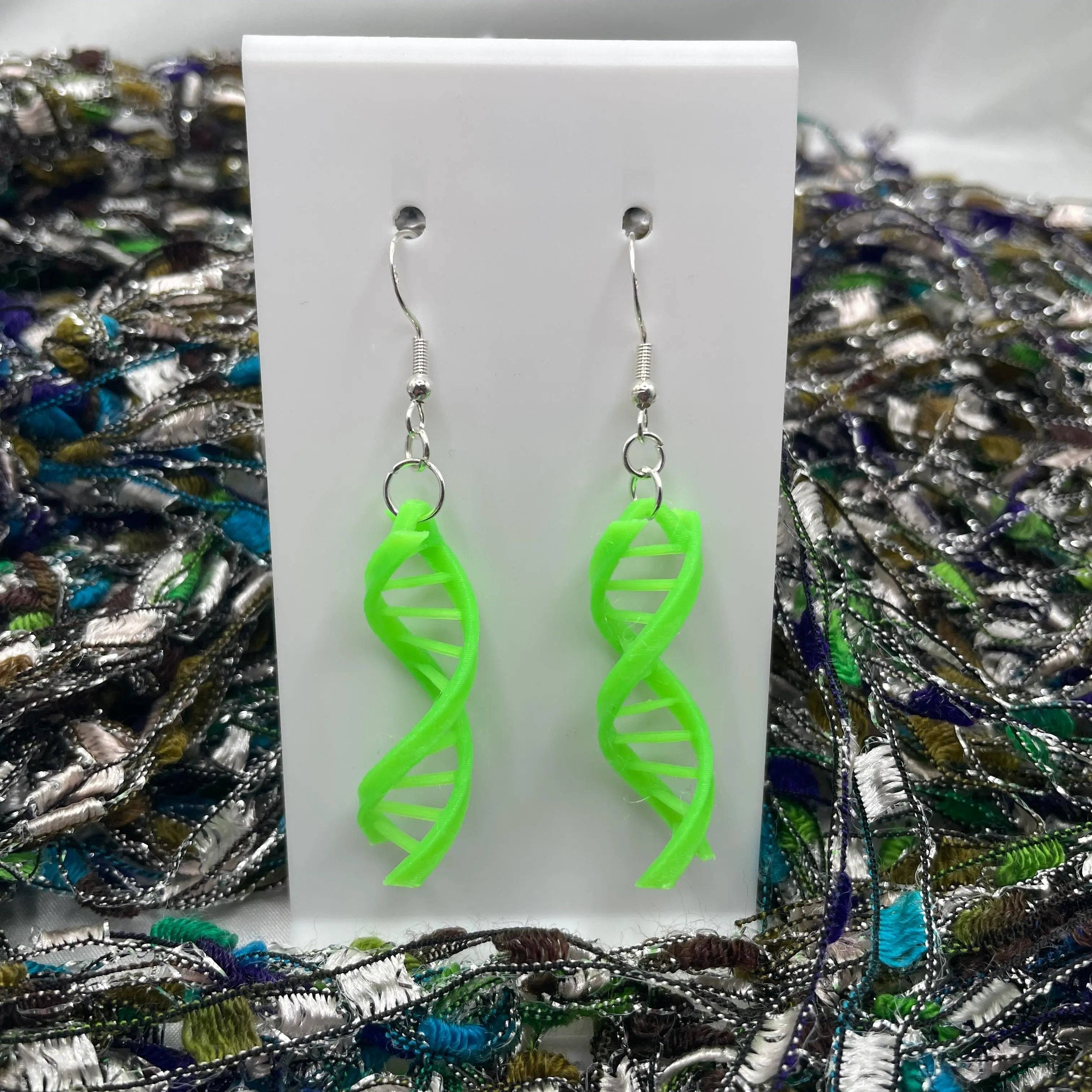 Double Helix DNA Dangle Earrings come in a glow-in-the-dark green color.