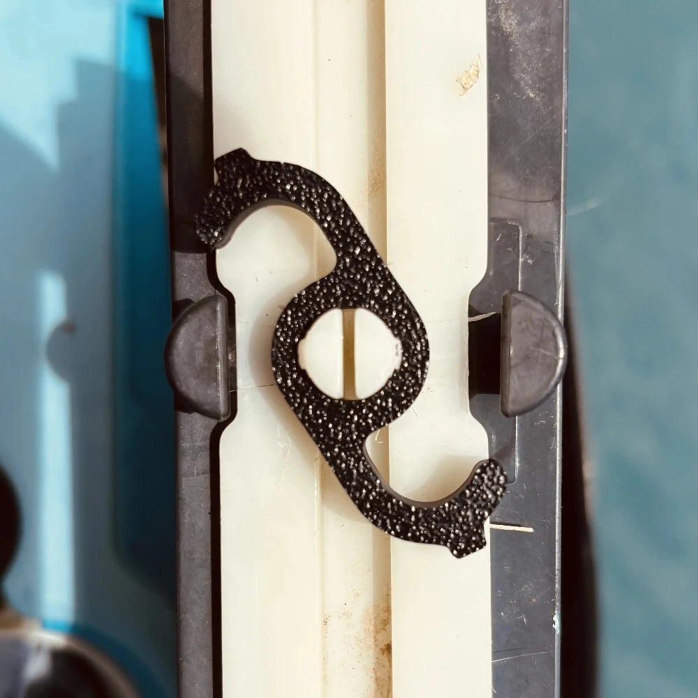 Close-up of a  black filter clip with a blurred background