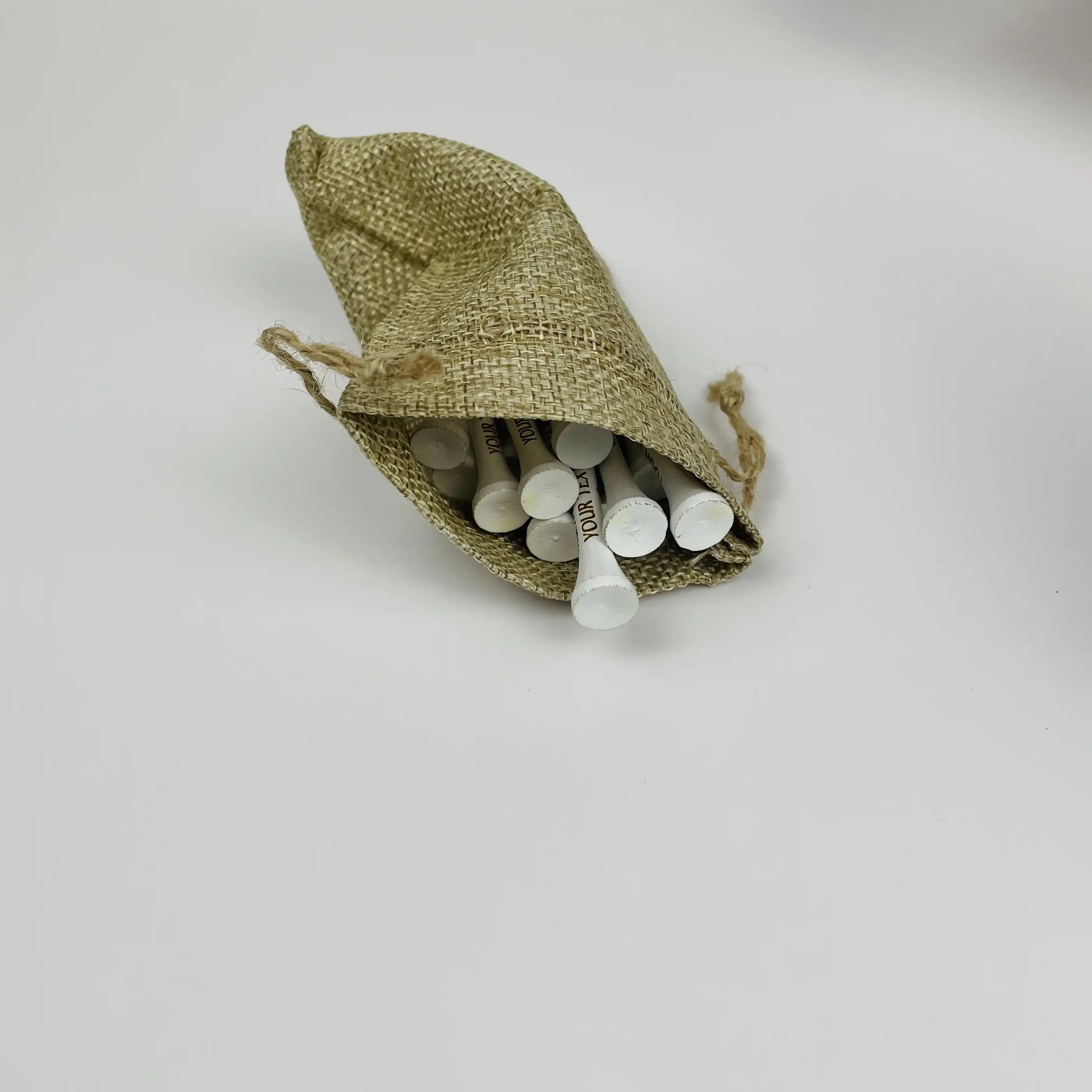 Small tan drawstring bag filled with white objects on a light gray background